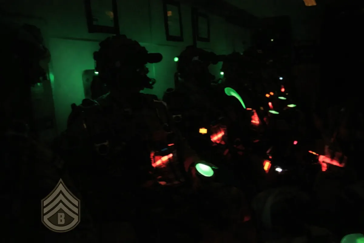 Military veterans in tactical gear illuminated by green light